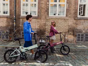 MATE E-Bikes – Junge und Mädchen gehen mit zwei E-Bikes auf der Straße