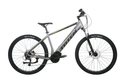 TOTEM Maurice E-Mountainbike in Silber auf Schotterweg – robustes Hardtail mit Vinka Mittelmotor