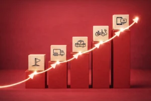 Aufsteigende Säulen mit Holz-Würfeln und Symbolen zeigen die Entwicklung von Meilensteinen bis zur E-Mobilität